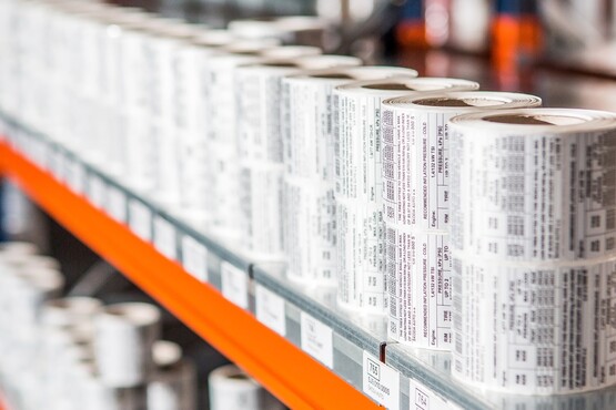 Vyskládané role průmyslových etiket na polici